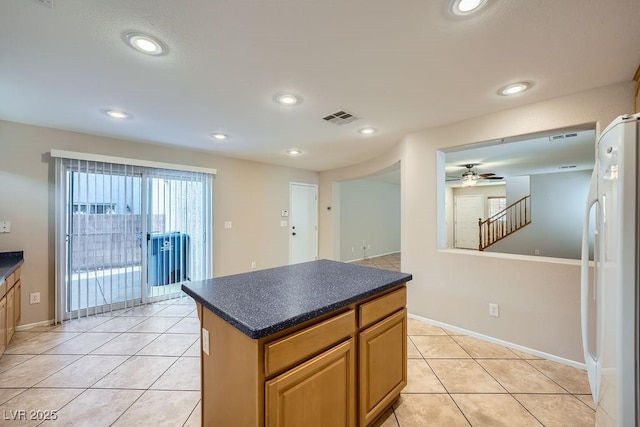 765 Jewel Tower St, Las Vegas, NV 89178 - kitchen with fridge, dark countertops, a ceiling fan, light tile patterned flooring, and recessed lighting