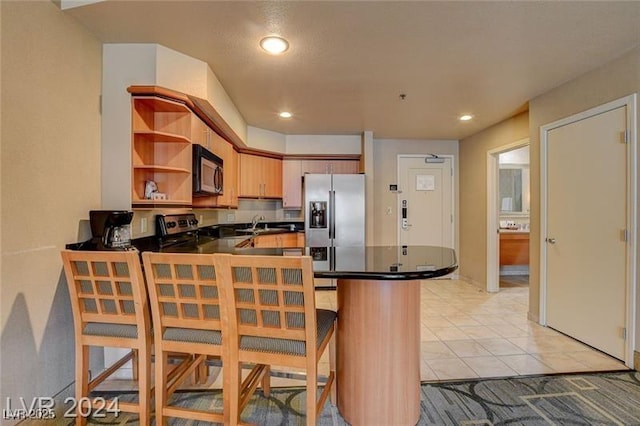211 E Flamingo Rd Unit 615, Las Vegas, NV 89169 - kitchen featuring stainless steel fridge with ice dispenser, black microwave, dark countertops, a peninsula, and open shelves