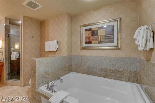 211 E Flamingo Rd Unit 615, Las Vegas, NV 89169 - bathroom with a bath, a shower stall, and tile patterned flooring