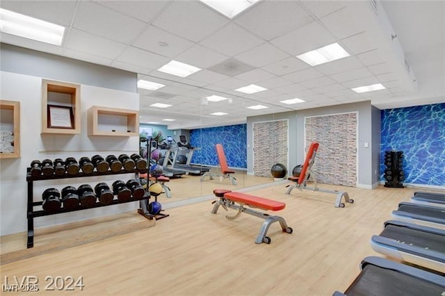 211 E Flamingo Rd Unit 615, Las Vegas, NV 89169 - workout area featuring wood finished floors, a drop ceiling, an accent wall, and baseboards