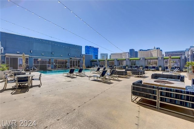 211 E Flamingo Rd Unit 615, Las Vegas, NV 89169 - community pool featuring a city view, an outdoor fire pit, and a patio