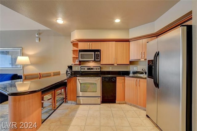 211 E Flamingo Rd Unit 615, Las Vegas, NV 89169 - kitchen with stainless steel appliances, a peninsula, dark countertops, a sink, and recessed lighting