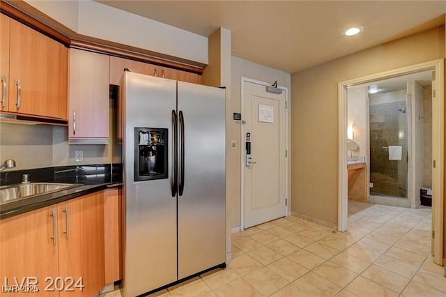 211 E Flamingo Rd Unit 615, Las Vegas, NV 89169 - kitchen with stainless steel refrigerator with ice dispenser, a sink, dark countertops, light tile patterned flooring, and recessed lighting