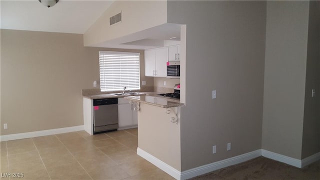 2777 Beaconfalls Way, Las Vegas, NV 89142 - kitchen with stainless steel appliances, white cabinetry, a peninsula, a breakfast bar area, and a sink