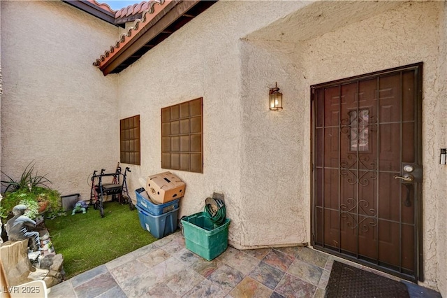 3987 Saddlewood Ct, Las Vegas, NV 89121 - entrance to property with stucco siding, a tiled roof, and a patio area