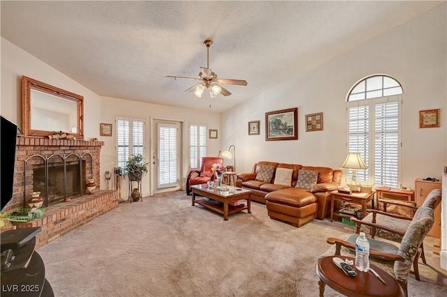 3987 Saddlewood Ct, Las Vegas, NV 89121 - carpeted living area with vaulted ceiling, a ceiling fan, plenty of natural light, a brick fireplace, and a textured ceiling