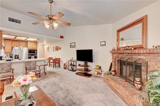 3987 Saddlewood Ct, Las Vegas, NV 89121 - living area with a brick fireplace, a ceiling fan, and light carpet