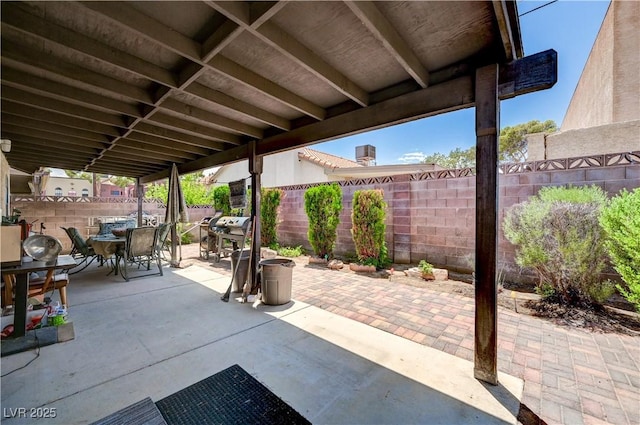 3987 Saddlewood Ct, Las Vegas, NV 89121 - fenced backyard featuring outdoor dining area, a patio area, and a grill