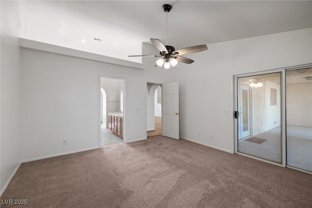 3580 S Shawnee Ave, Pahrump, NV 89048 - unfurnished bedroom featuring light colored carpet, baseboards, ensuite bath, and arched walkways