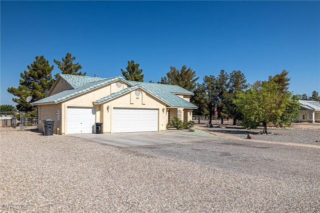 3580 S Shawnee Ave, Pahrump, NV 89048 - view of front of home featuring an attached garage, driveway, and stucco siding