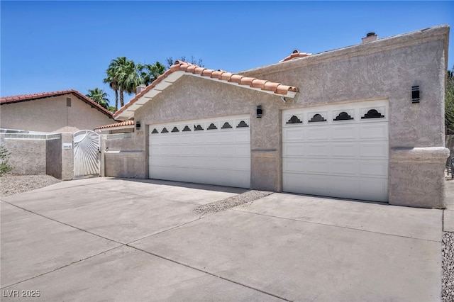 3421 Rochelle Ct, Las Vegas, NV 89121 - view of front of property with a gate, stucco siding, driveway, and a tile roof