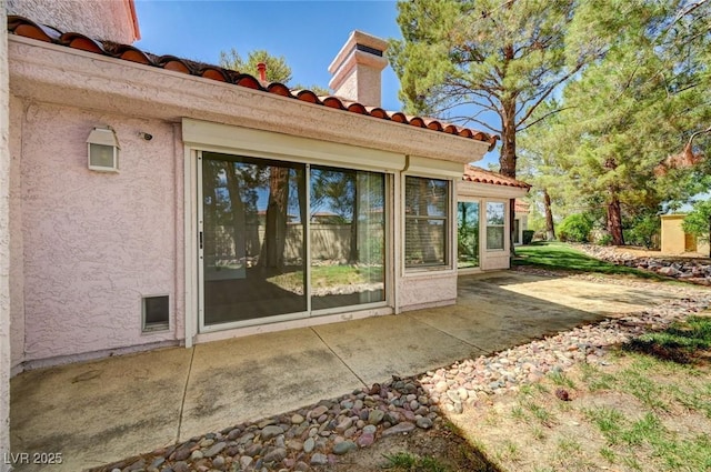 6944 Emerald Springs Ln, Las Vegas, NV 89113 - rear view of house with a patio area, a tile roof, stucco siding, and a chimney
