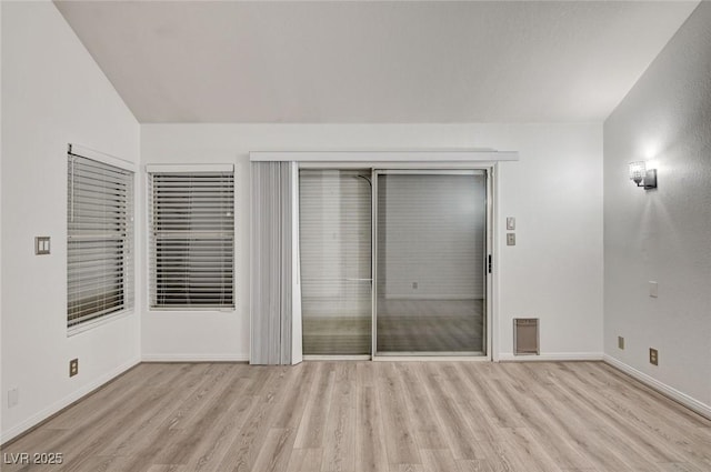 6944 Emerald Springs Ln, Las Vegas, NV 89113 - unfurnished bedroom featuring wood finished floors and vaulted ceiling