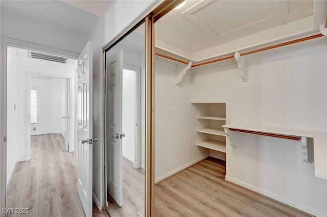 6944 Emerald Springs Ln, Las Vegas, NV 89113 - walk in closet featuring light wood finished floors and attic access