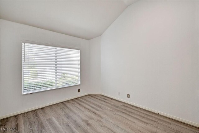 6944 Emerald Springs Ln, Las Vegas, NV 89113 - empty room featuring light wood finished floors and vaulted ceiling