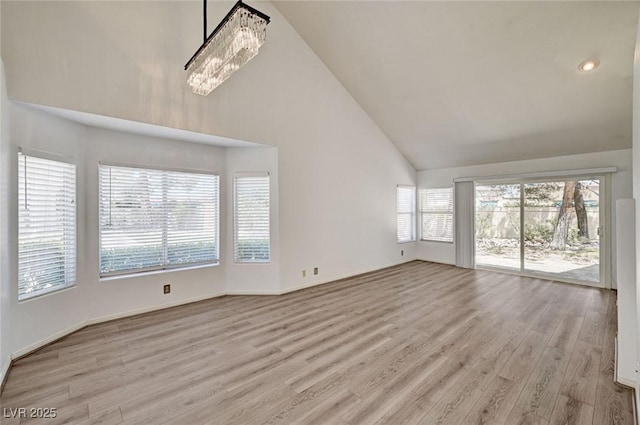 6944 Emerald Springs Ln, Las Vegas, NV 89113 - unfurnished living room featuring high vaulted ceiling and wood finished floors