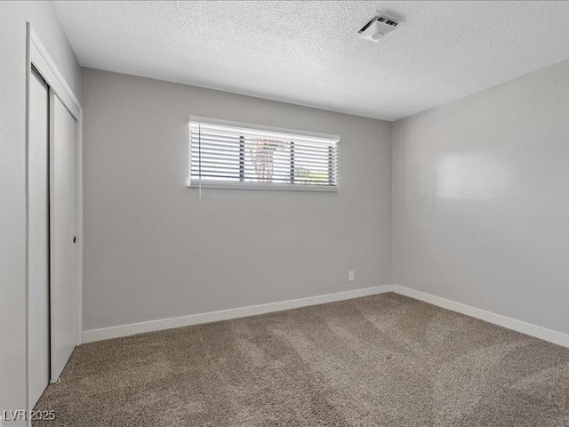 4204 El Jardin Ave, Las Vegas, NV 89102 - unfurnished bedroom featuring a closet, a textured ceiling, carpet flooring, and baseboards