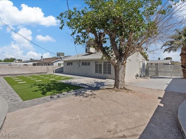 4204 El Jardin Ave, Las Vegas, NV 89102 - back of property with stucco siding, a patio, and a gate