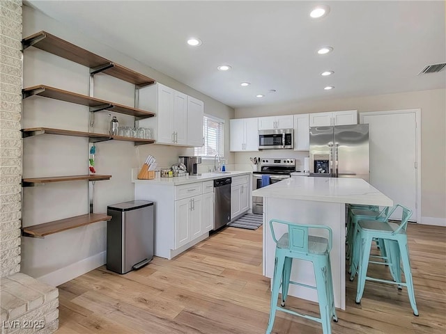 4072 E Harmon Ave, Las Vegas, NV 89121 - kitchen with appliances with stainless steel finishes, light wood-style floors, light countertops, and recessed lighting