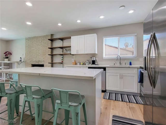4072 E Harmon Ave, Las Vegas, NV 89121 - kitchen featuring stainless steel appliances, a sink, a center island, recessed lighting, and a breakfast bar area
