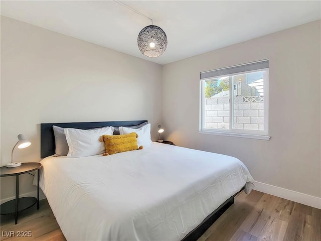 4072 E Harmon Ave, Las Vegas, NV 89121 - bedroom with light wood-style floors and baseboards