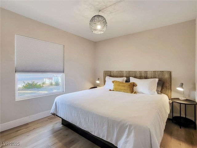 4072 E Harmon Ave, Las Vegas, NV 89121 - bedroom featuring baseboards and wood finished floors
