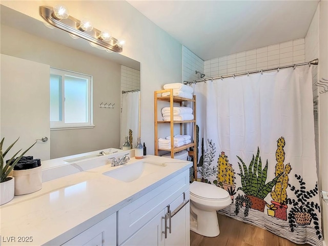4072 E Harmon Ave, Las Vegas, NV 89121 - bathroom with vanity, toilet, wood finished floors, and a shower with shower curtain