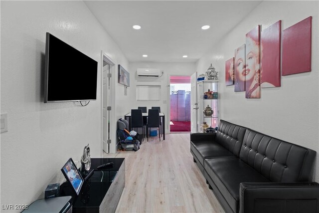 5375 Chestnut St, Las Vegas, NV 89119 - living area featuring an AC wall unit, wood finished floors, and recessed lighting