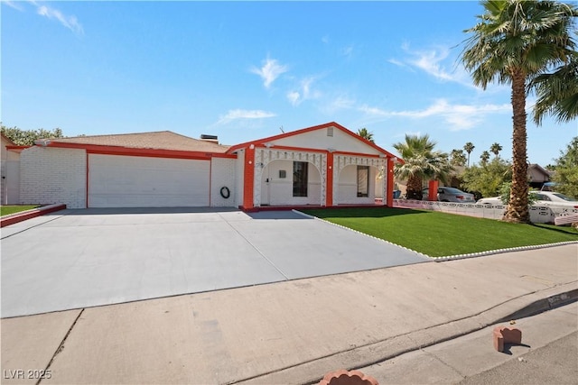 5375 Chestnut St, Las Vegas, NV 89119 - view of front of home featuring a garage, a front yard, and concrete driveway
