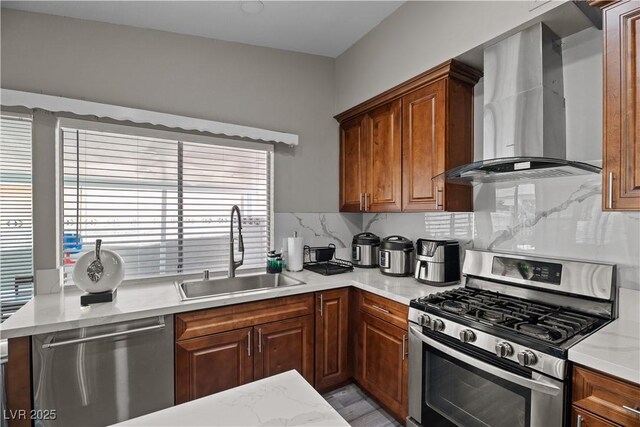 5375 Chestnut St, Las Vegas, NV 89119 - kitchen with appliances with stainless steel finishes, wall chimney range hood, backsplash, and brown cabinets