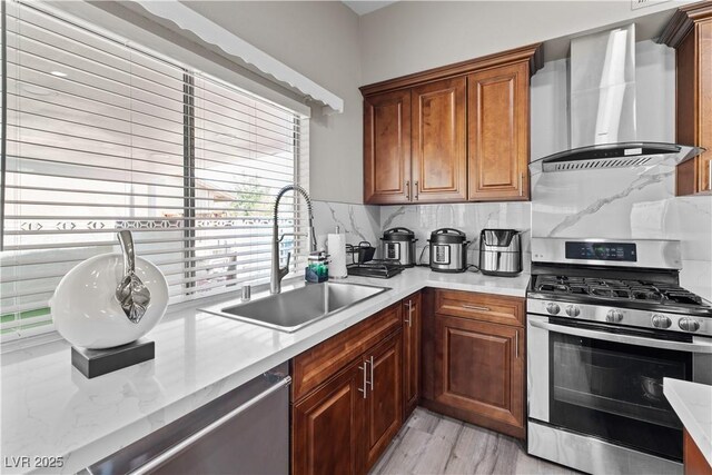 5375 Chestnut St, Las Vegas, NV 89119 - kitchen featuring stainless steel appliances, wall chimney range hood, decorative backsplash, and light countertops