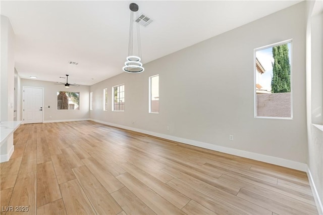 10017 Snow Crest Pl, Las Vegas, NV 89134 - unfurnished living room with light wood-style floors, baseboards, and a ceiling fan