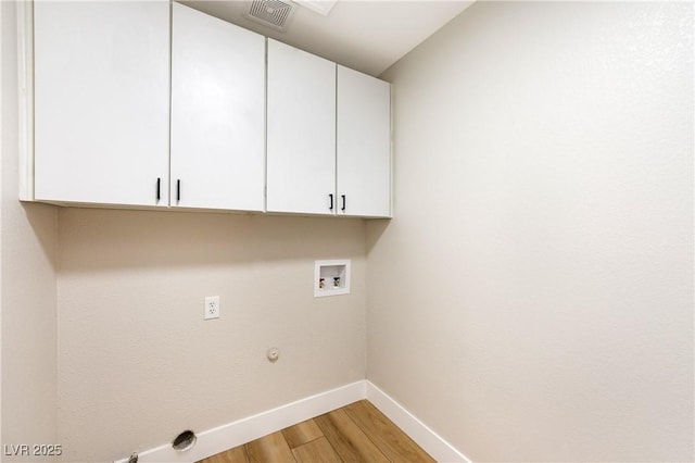 10017 Snow Crest Pl, Las Vegas, NV 89134 - laundry area with cabinet space, baseboards, light wood finished floors, hookup for a washing machine, and gas dryer hookup