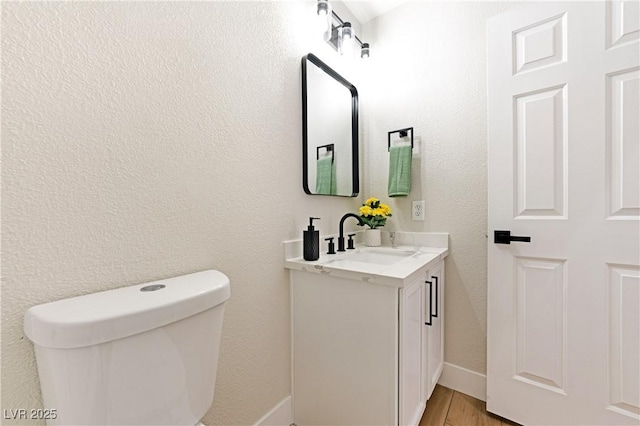 10017 Snow Crest Pl, Las Vegas, NV 89134 - bathroom with vanity, toilet, wood finished floors, and baseboards