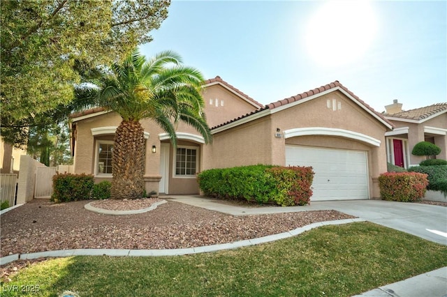 10017 Snow Crest Pl, Las Vegas, NV 89134 - mediterranean / spanish-style house featuring stucco siding, an attached garage, driveway, and a tile roof