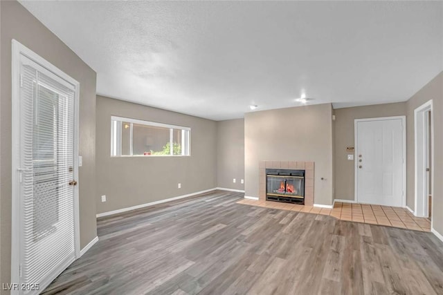 701 Capri Dr Unit 6A, Boulder City, NV 89005 - unfurnished living room featuring wood finished floors, baseboards, and a tile fireplace