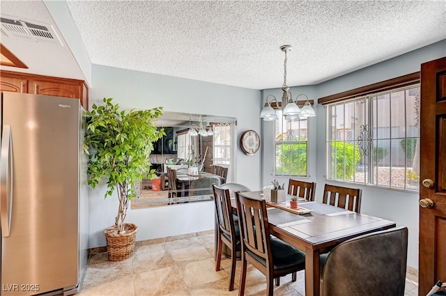 7952 Diamond Rock Way Unit 102, Las Vegas, NV 89128 - dining area with a chandelier and a textured ceiling