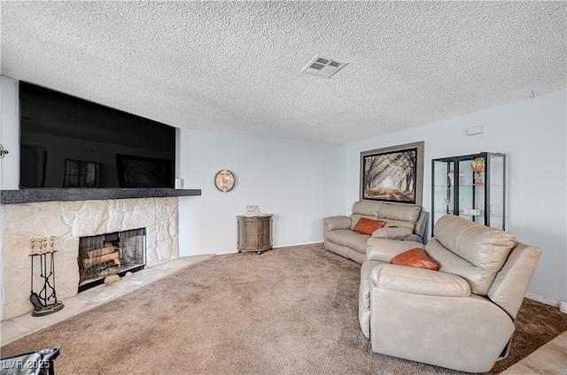 7952 Diamond Rock Way Unit 102, Las Vegas, NV 89128 - living area with a stone fireplace, a textured ceiling, and carpet flooring