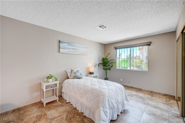 7952 Diamond Rock Way Unit 102, Las Vegas, NV 89128 - bedroom with a textured ceiling and a closet