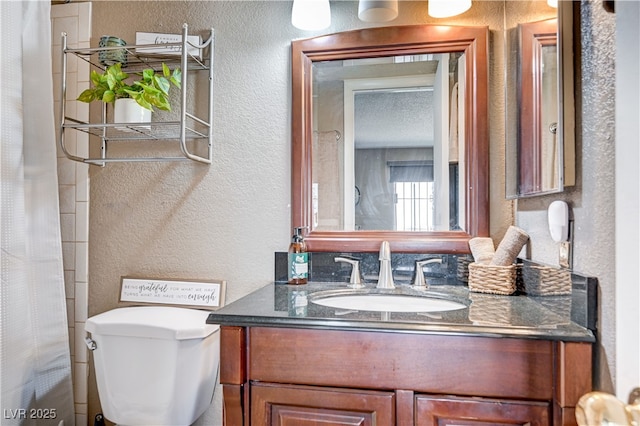 7952 Diamond Rock Way Unit 102, Las Vegas, NV 89128 - bathroom with a textured wall, vanity, toilet, and a shower with shower curtain