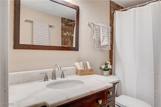 7952 Diamond Rock Way Unit 102, Las Vegas, NV 89128 - bathroom with vanity, a textured wall, and a shower with curtain
