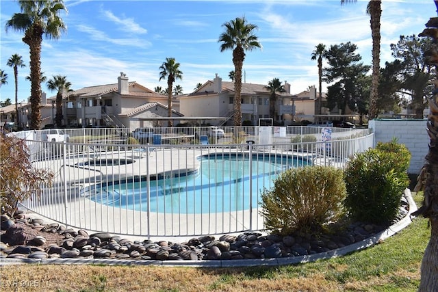 7952 Diamond Rock Way Unit 102, Las Vegas, NV 89128 - community pool featuring a fenced backyard and a residential view