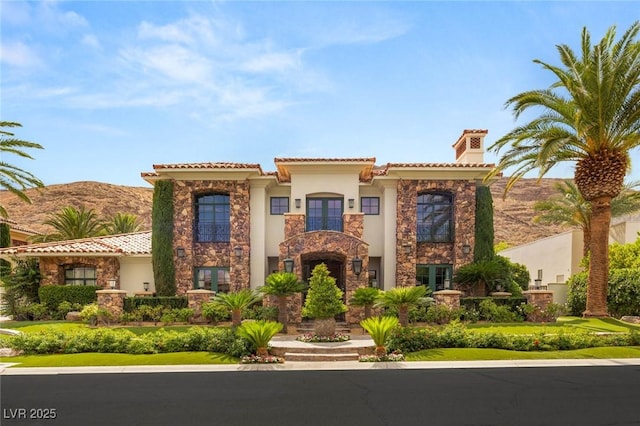 2793 Red Arrow Dr, Las Vegas, NV 89135 - mediterranean / spanish house featuring a chimney, stone siding, french doors, and stucco siding