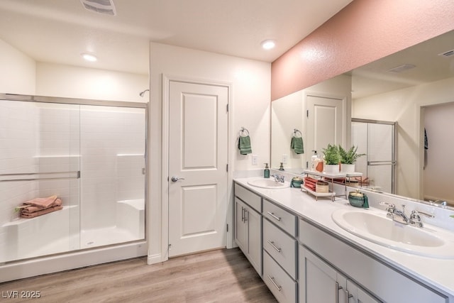 1421 Gable Falls Pl Unit 92, North Las Vegas, NV 89084 - full bathroom with double vanity, a stall shower, and wood finished floors