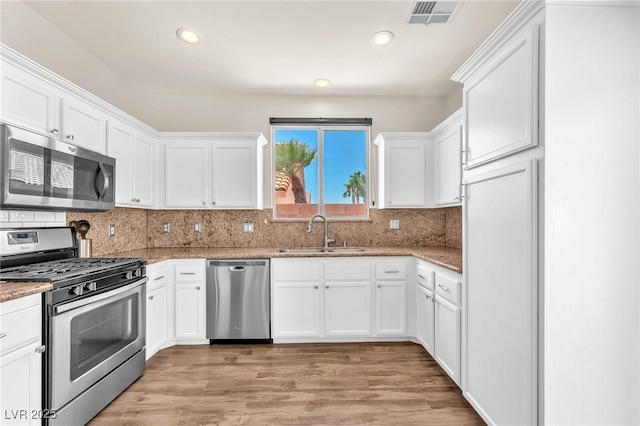 690 Great Dane Ct, Henderson, NV 89052 - kitchen featuring stainless steel appliances, white cabinets, recessed lighting, light wood-style floors, and light stone countertops