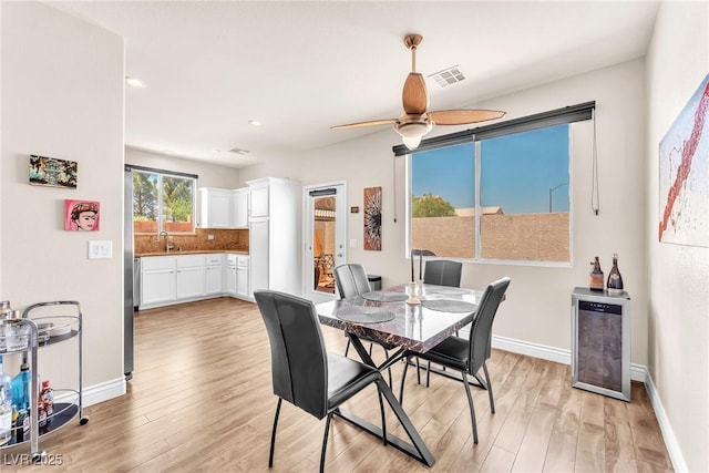 690 Great Dane Ct, Henderson, NV 89052 - dining room with wine cooler, light wood-style floors, ceiling fan, and recessed lighting