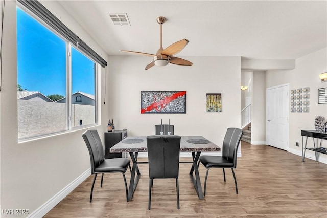 690 Great Dane Ct, Henderson, NV 89052 - dining space featuring stairs, wood finished floors, and a ceiling fan