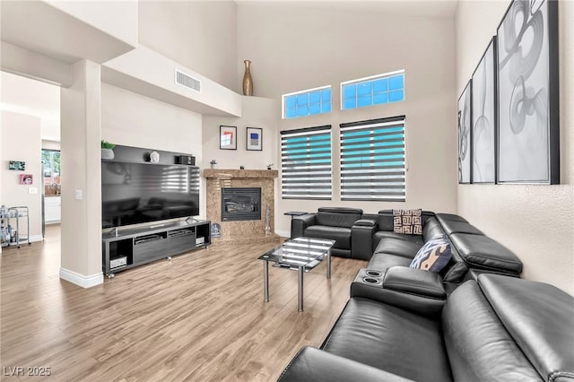 690 Great Dane Ct, Henderson, NV 89052 - living room featuring a high ceiling, wood finished floors, and a premium fireplace