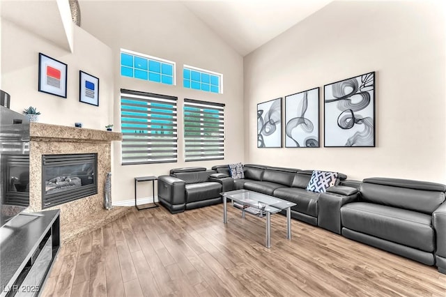 690 Great Dane Ct, Henderson, NV 89052 - living area featuring wood finished floors, high vaulted ceiling, and a high end fireplace