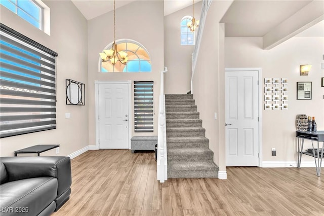 690 Great Dane Ct, Henderson, NV 89052 - foyer entrance featuring a chandelier, light wood-style flooring, stairway, and a high ceiling